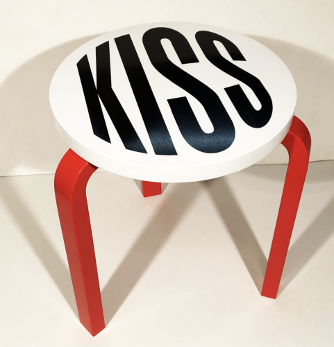 Barbara Kruger Untitled (Kiss) wooden stool with bold black KISS text on white seat and red legs, minimalist and conceptual.