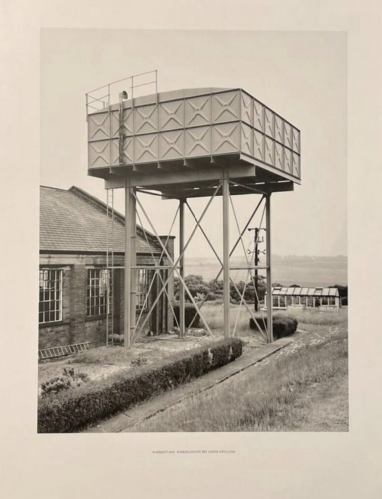 Bernd and Hilla Becher Wasserturm Kirkhamgate offset lithograph of elevated water tank on stilts next to industrial building, black and white