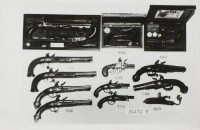 Black and white photograph by Andy Warhol featuring an array of antique pistols arranged catalog-style, including boxed dueling sets.