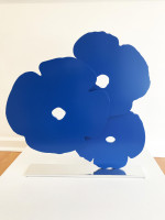 Donald Sultan's Blue Poppies 2015 sculpture with three abstract blue poppy shapes made of painted aluminum on a polished aluminum base.