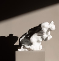 Eva Claessens Embrace marble sculpture depicting intertwined abstract figures with soft curves and a polished white surface.