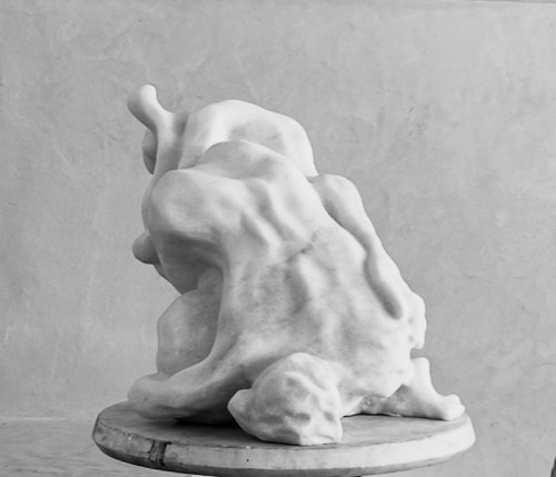 Eva Claessens Embrace marble sculpture depicting intertwined abstract figures with soft curves and a polished white surface.
