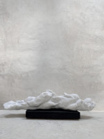 Eva Claessens Seeking the Silence 2025 marble sculpture of low elongated form on dark base against light wall  