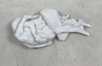 Eva Claessens Dao 2025 marble sculpture of elongated reclining form on dark base against textured wall  