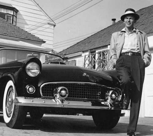 Frank Worth, Frank Sinatra next to his T-Bird, black-and-white photograph of Sinatra standing casually by his car in a driveway.