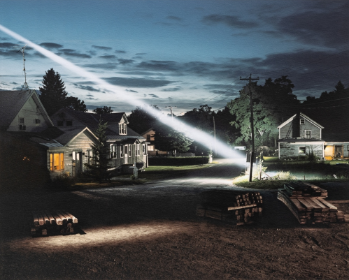Gregory Crewdson Untitled (Ray of Light) photograph of suburban street at twilight with dramatic beam of light crossing diagonally.