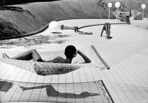 Martine Franck, Swimming Pool (by Alain Capeilleres), black-and-white photo of modernist poolside scene with geometric patterns and relaxed figures.