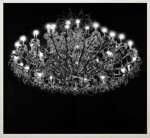 Robert Longo Crystal Chandelier pigment print showing ornate chandelier glowing against a solid black background. 