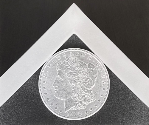 Robert Mapplethorpe Silver Dollar 1988 silver gelatin print of a 1900 coin in white mat on dark background  